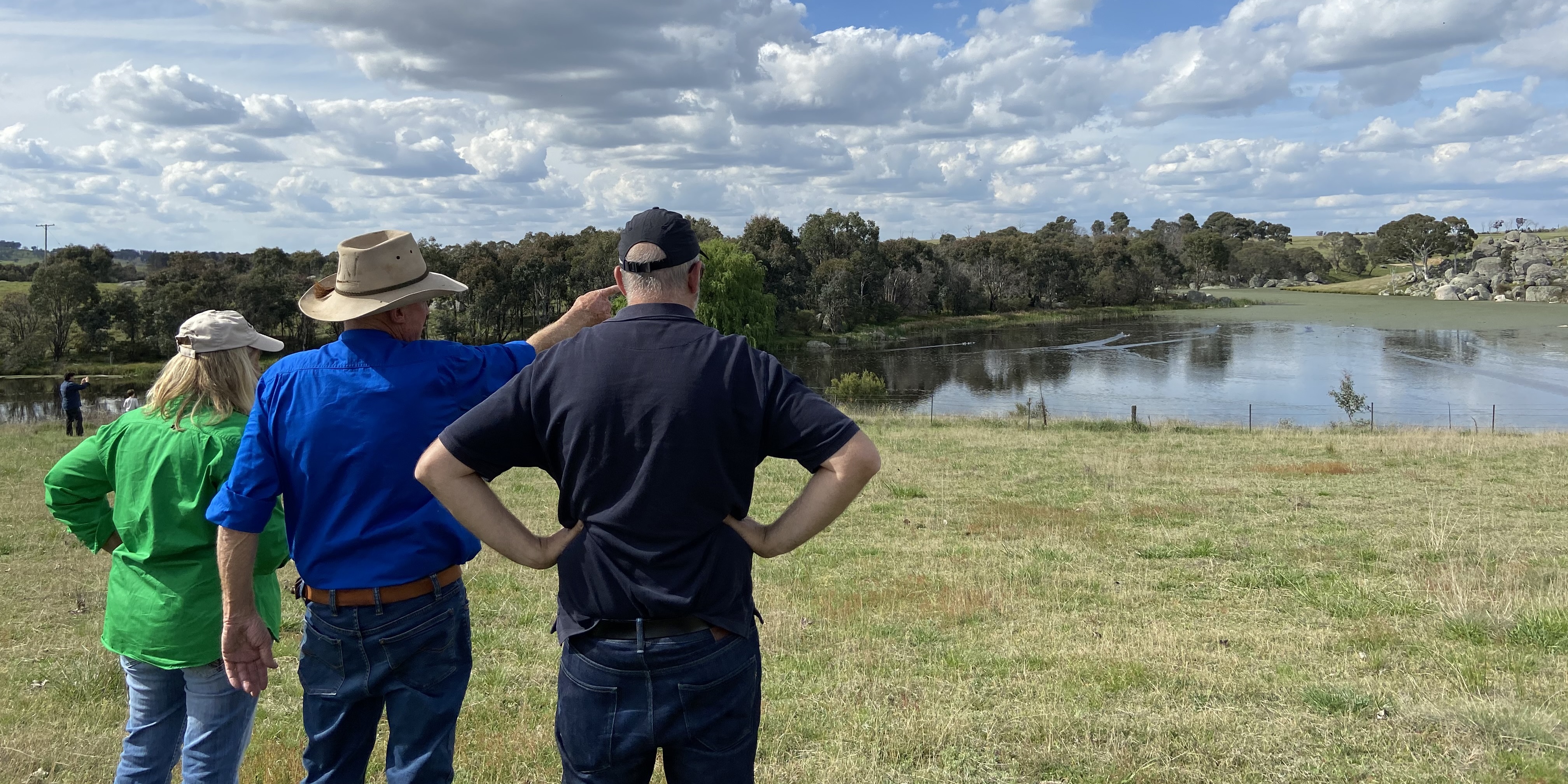 People pointing out features of Kentucky Creek Dam