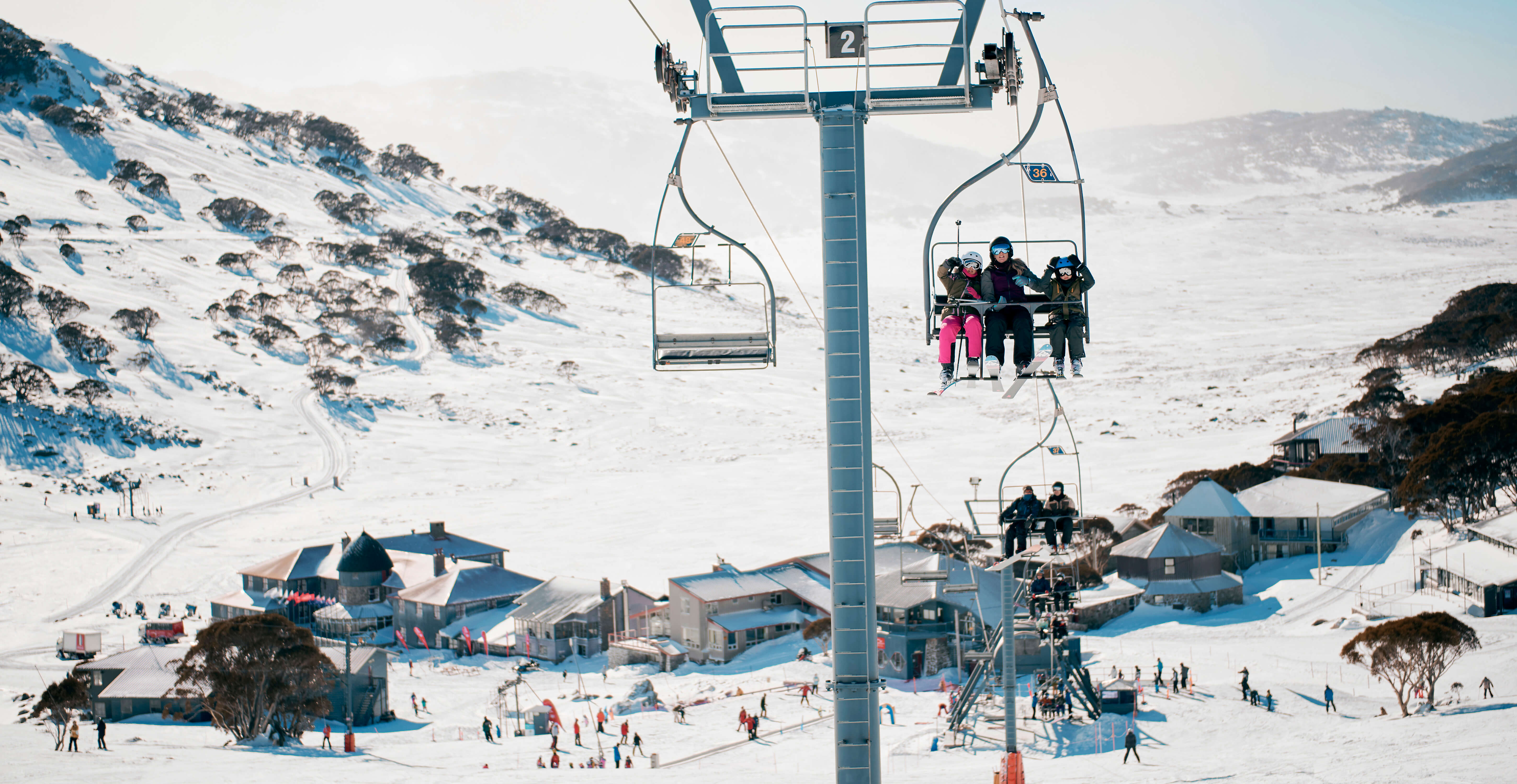 View of a skiing station with a family in a chair lift.