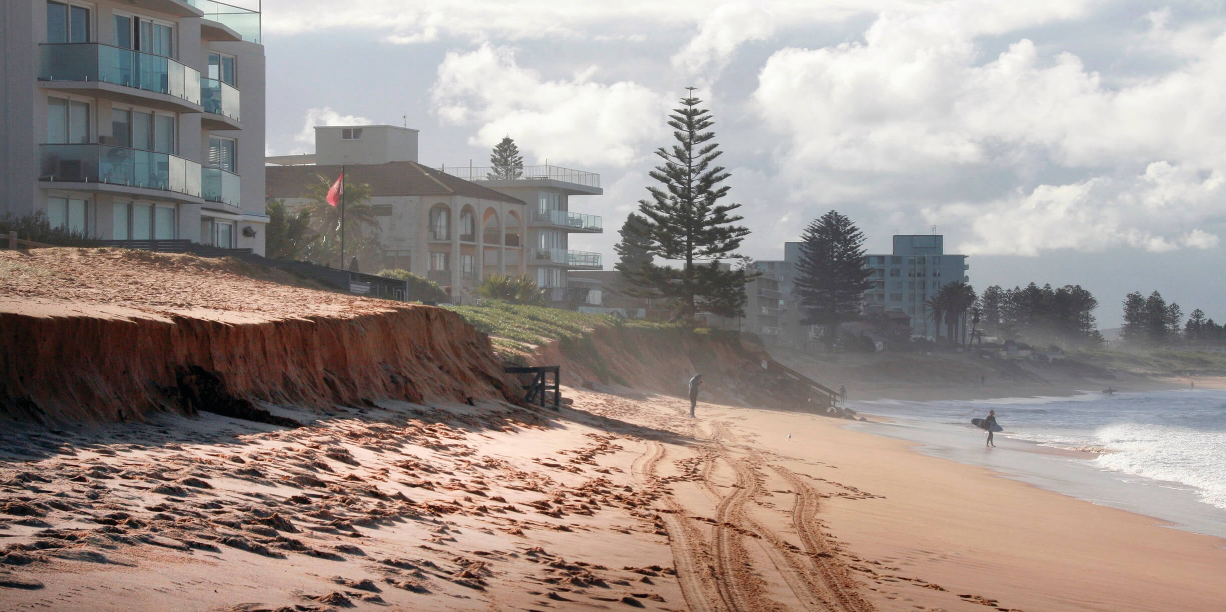 Beach erosion close to habitations in stormy weather.
