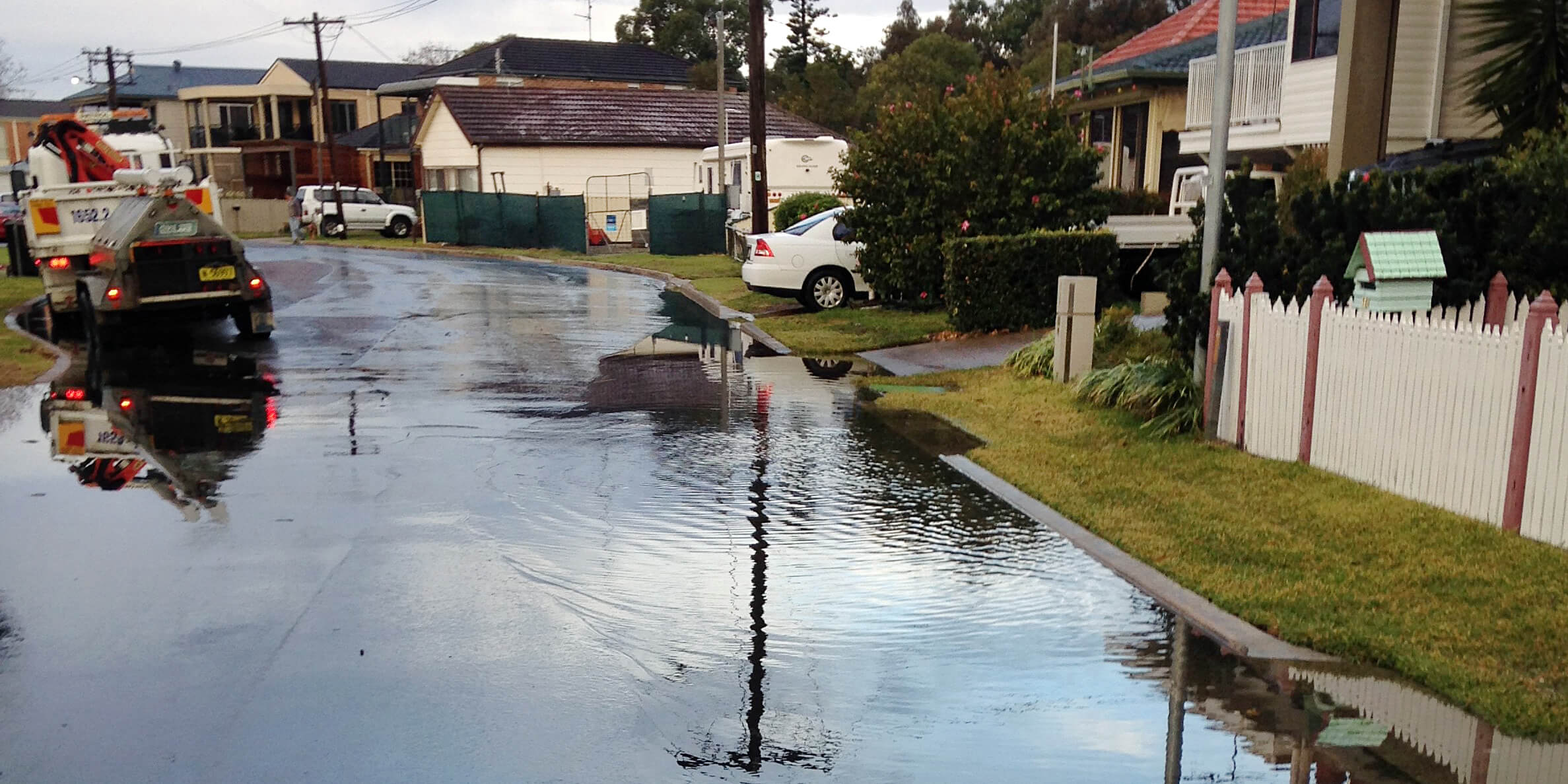 Coastal inundation flooding a neighbourhood street 