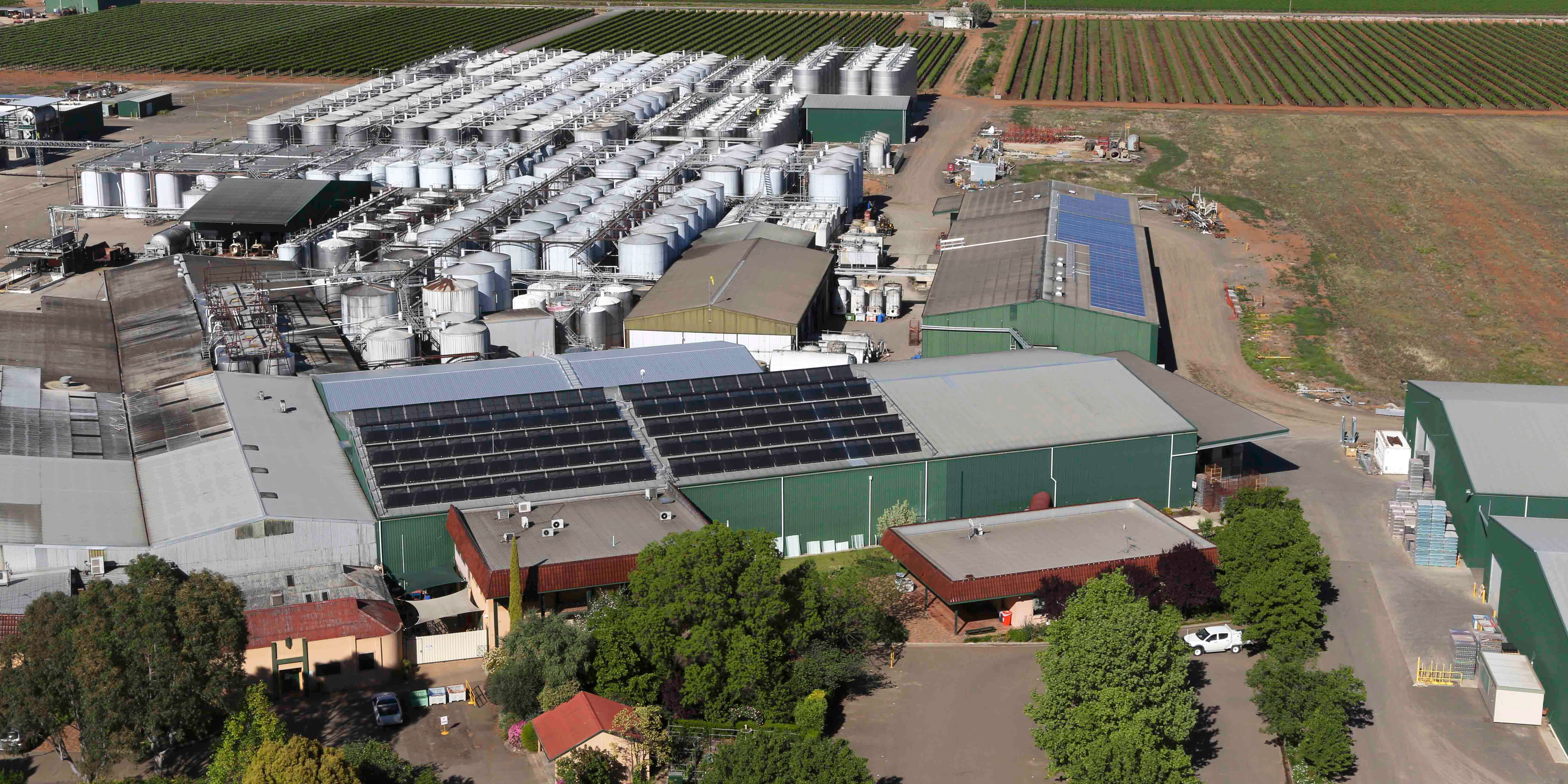 Oblique aerial image showing a large wine making facility covered in rooftop solar