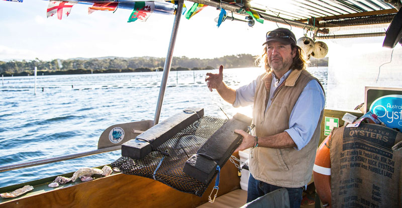 Oyster tour guide on his boat speaking