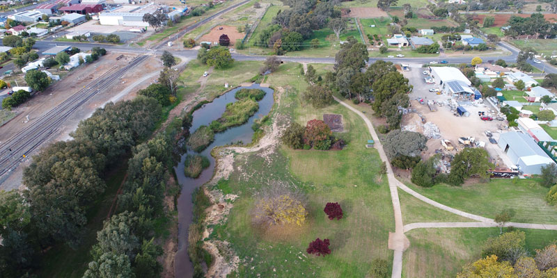Aerial view of a wetland, trees and built environment