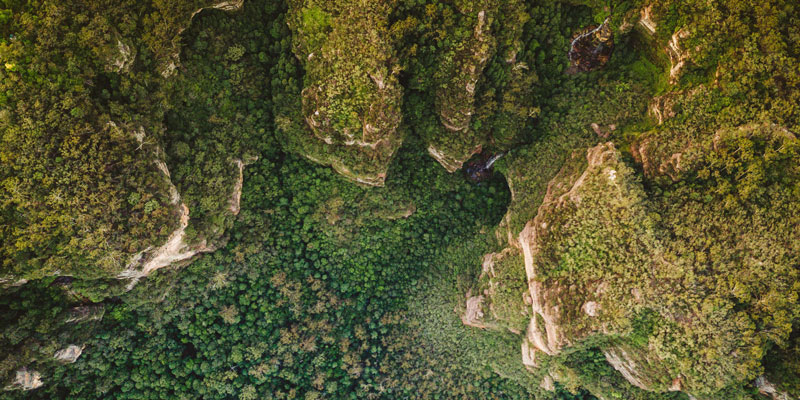 Aerial view of cliffs, bush and waterfalls