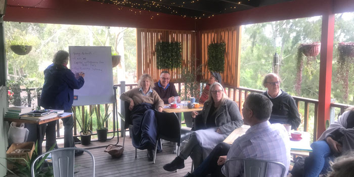 A group of people sitting a climate cafe