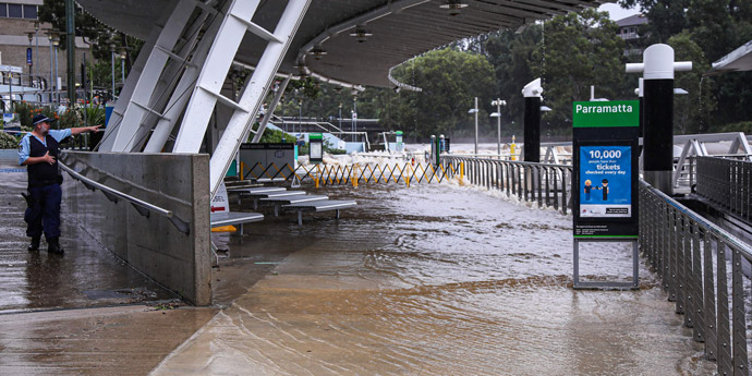 flooded ferry terminal with a police officer standing to the left