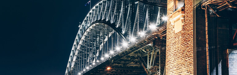 Close up of the Sydney Harbour bridge lit up at night