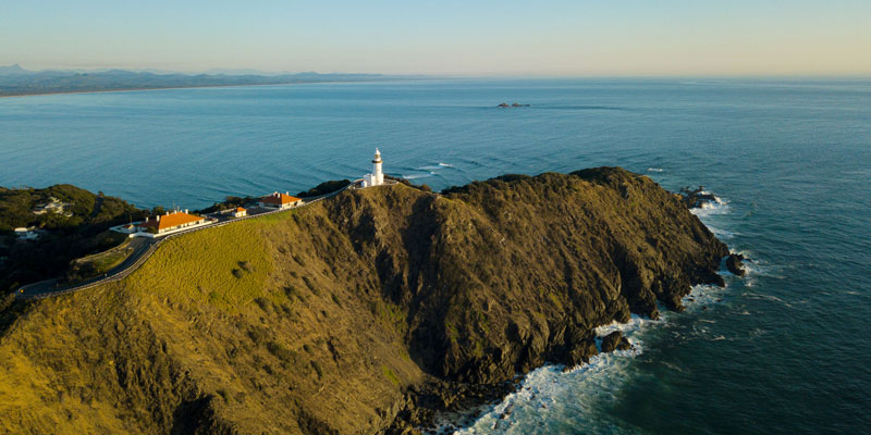 Aerial view of Cape Byron Lighthouse with the ocean.