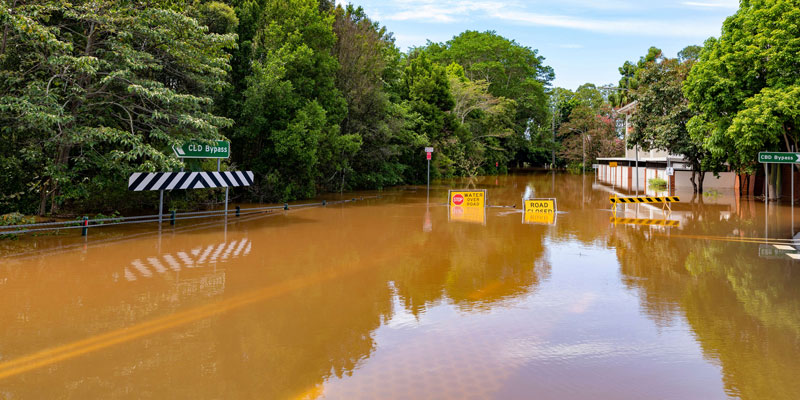 Flooded road with flood sign under water