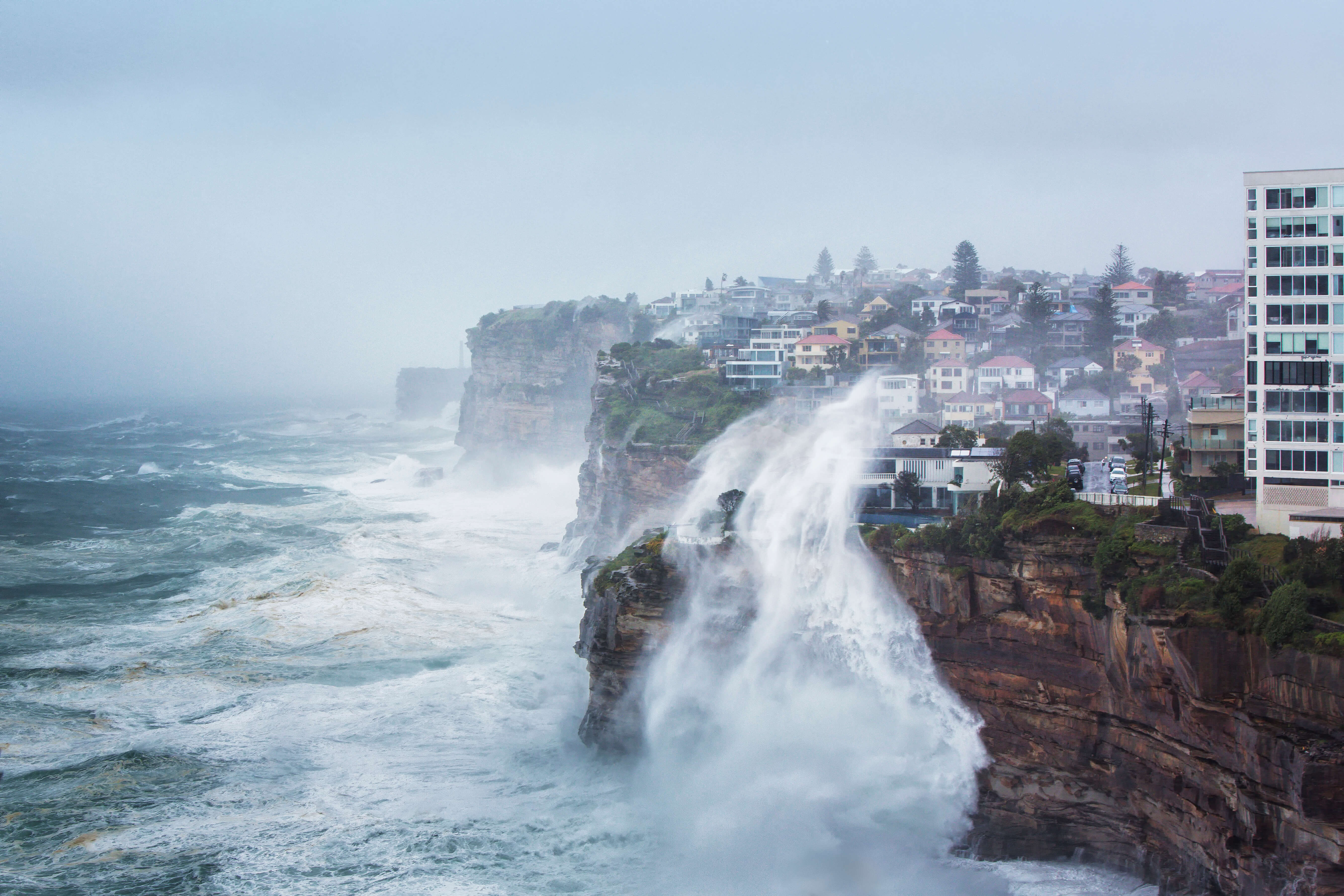 Wave crashing over the cliff side