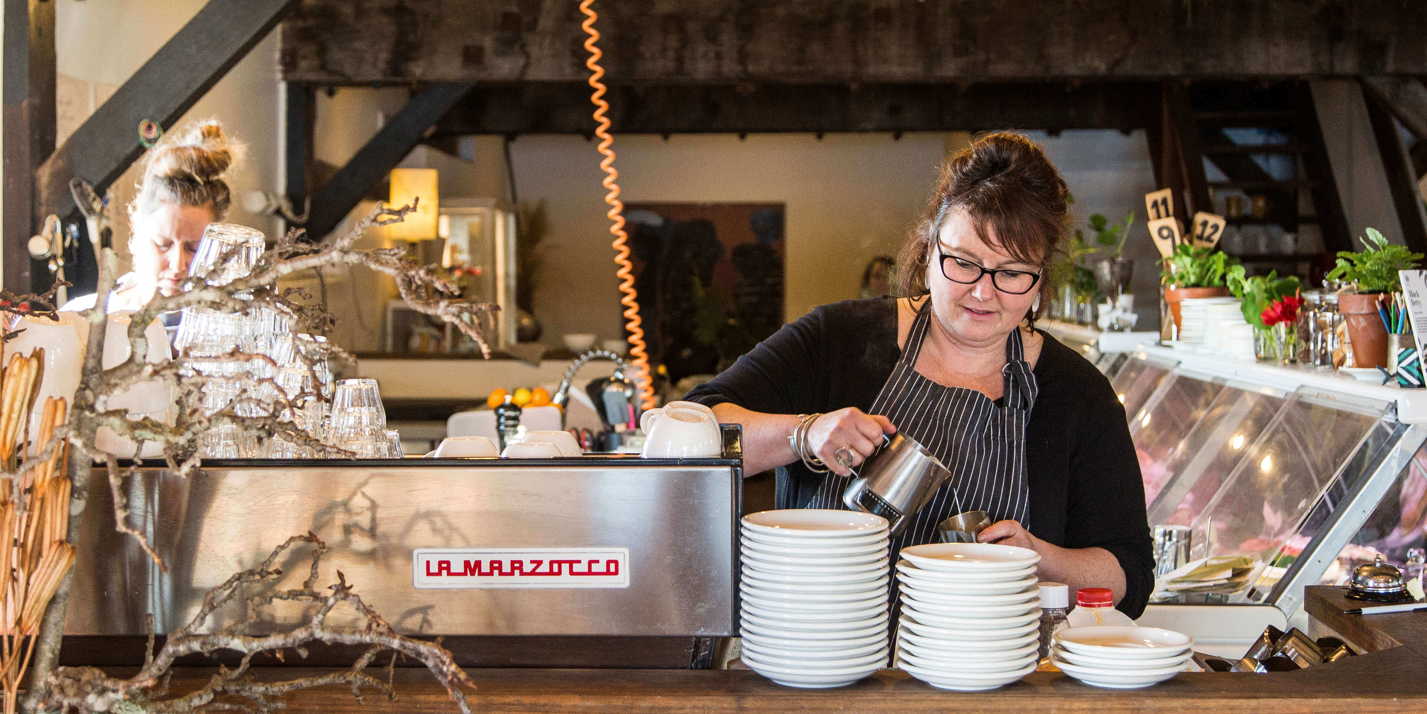 Barista making coffee at The Wharf Local cafe in Tathra.