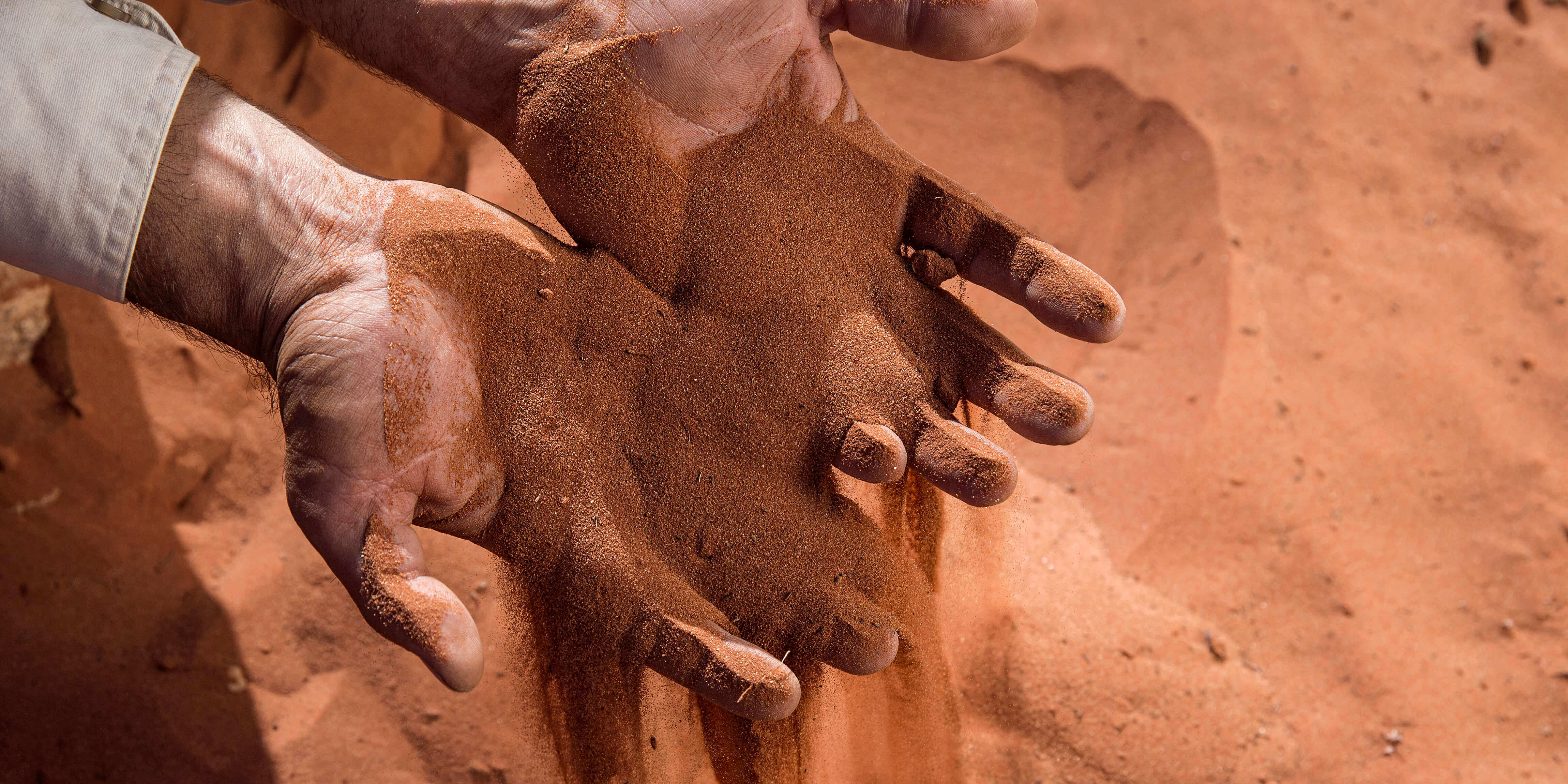 2 hands showing sands as part of an Aboriginal art and culture guided tour