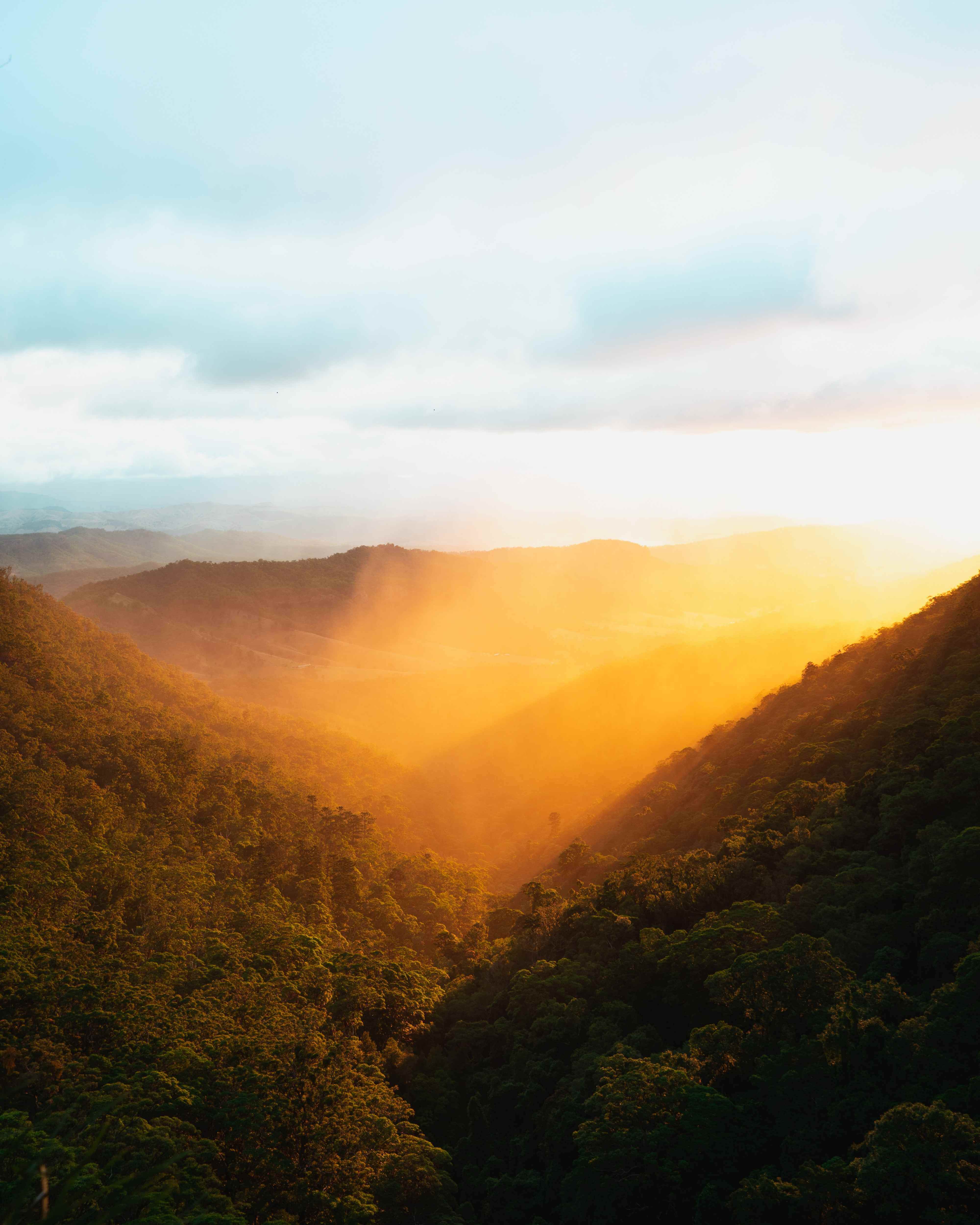 image of the sun rising in a valley