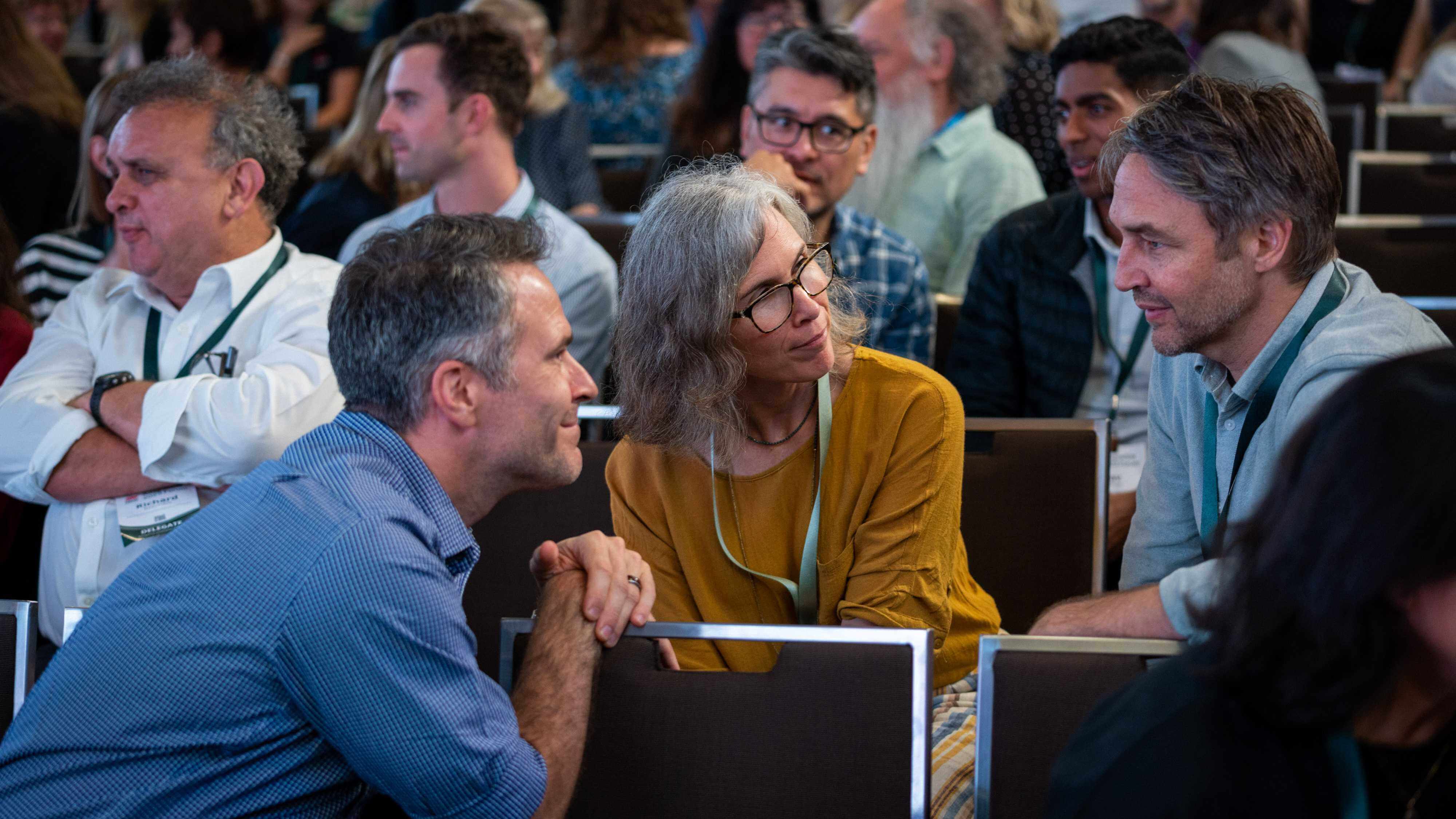 Three people seated engaged in conversation at the AdaptNSW 2023 Forum.