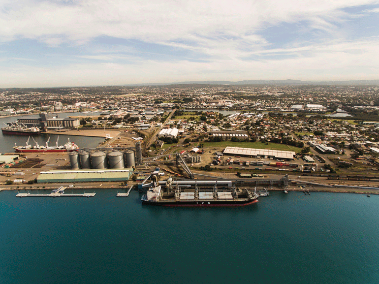 Aerial view of large ships at the mouth of the Hunter River, Newcastle 