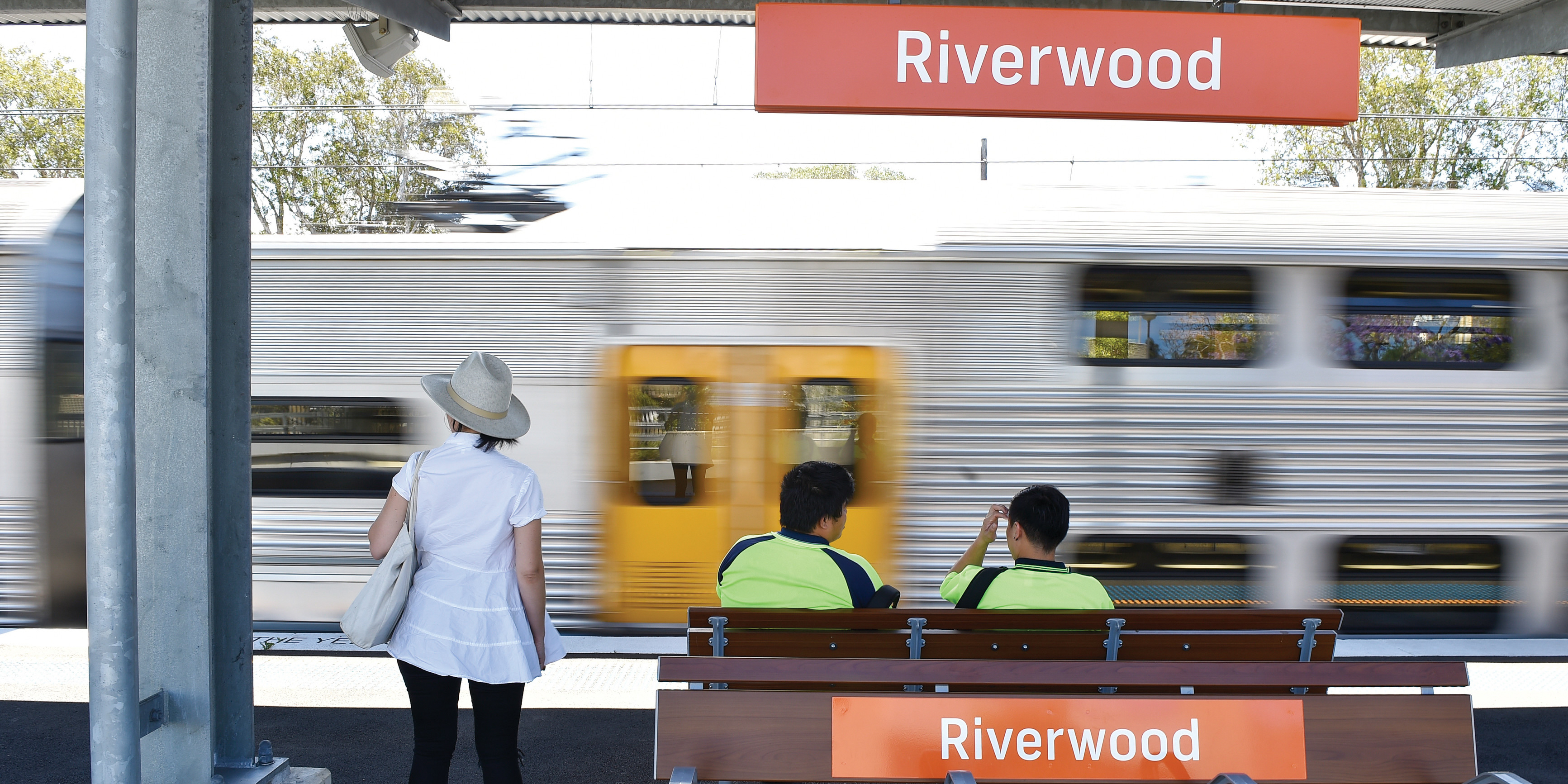 Passengers wait at a train station in Riverwood, NSW.