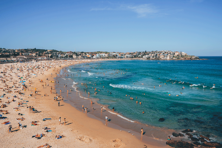 A crowded scene of Bondi Beach on a hot sunny day. 