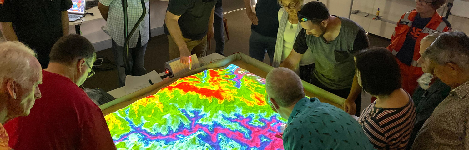 group of people assessing bushfire risk with the use of an electronic table