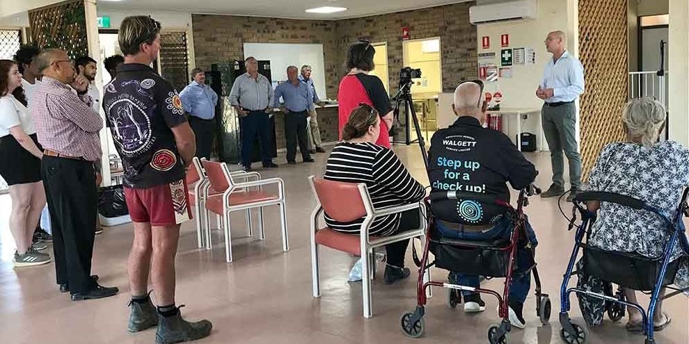 A group of people listening intently to a speaker