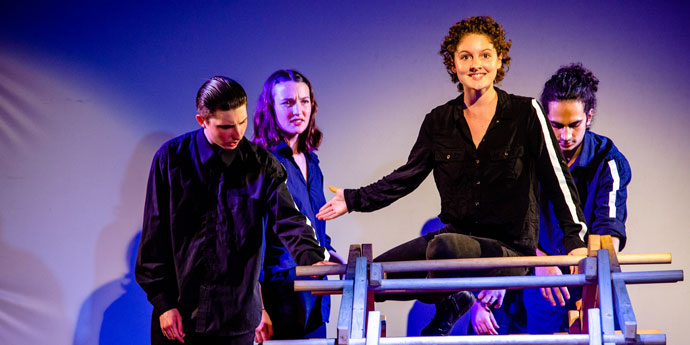 Group of people acting on stage Byron Youth Theatre