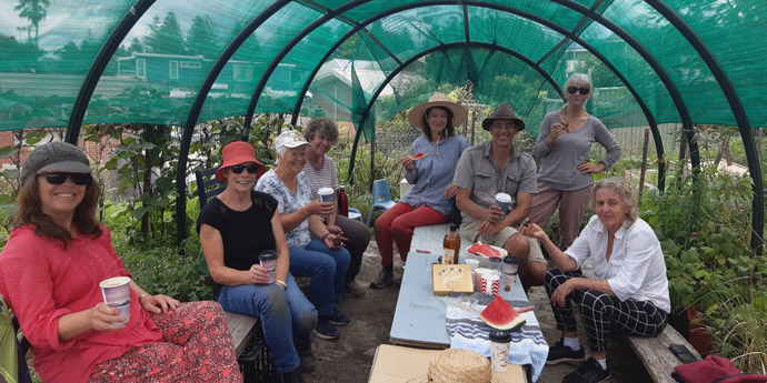 Moodji Volunteers gather under shade cloth 