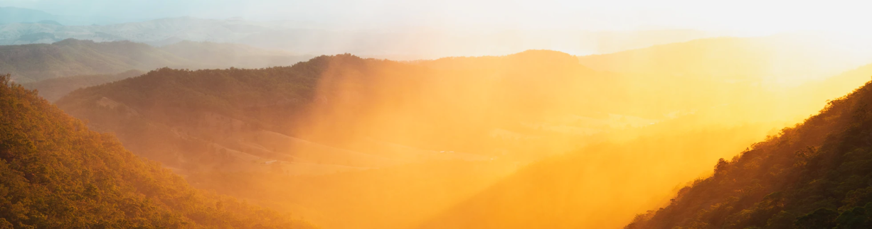 Sun rising in a valley